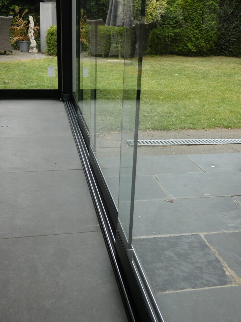 Overkapping-wit-met houten-zijwanden-met-antraciete-schuifwand-Deurne-rail-glaswand